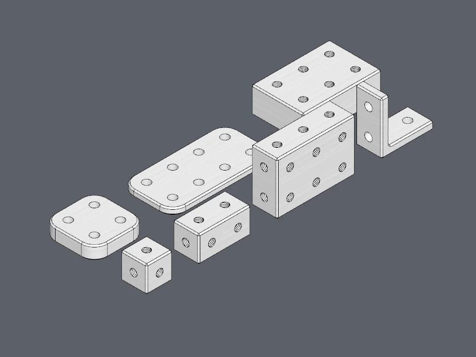 Blocks, plates and an L bracket of different sizes: every one is a whole number of cells, with its holes on the grid.