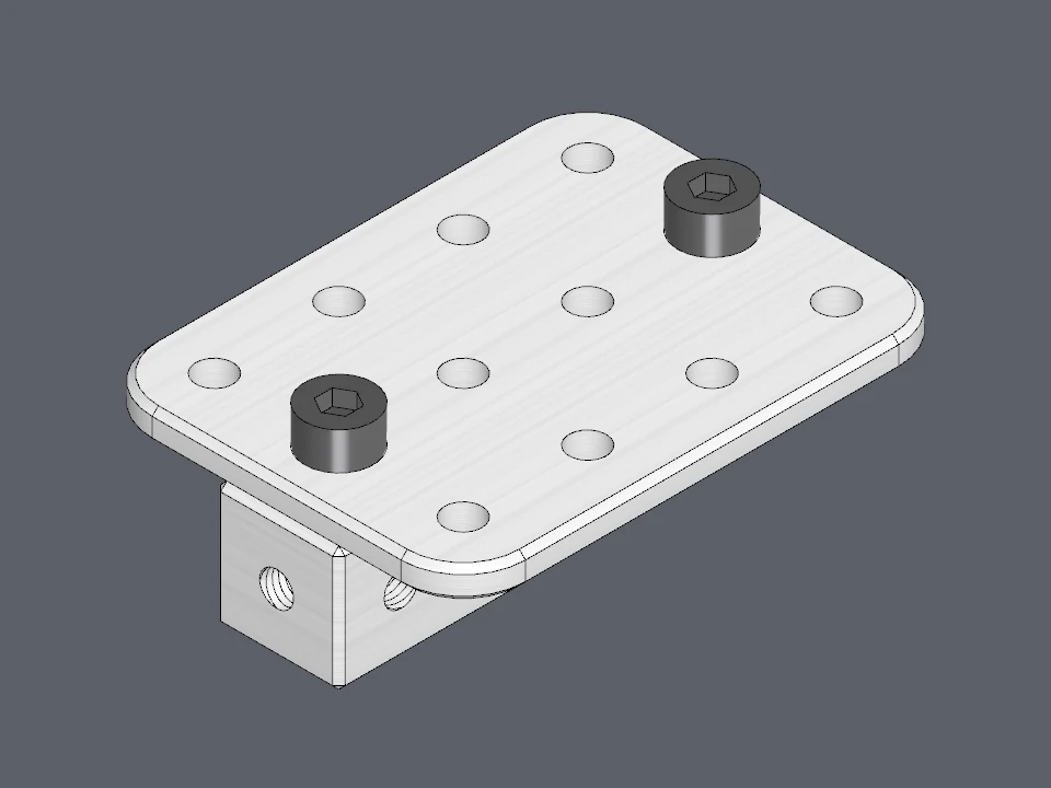 A plate held to a block by two M3 screws: every hole lines up because both sit on the 10 mm grid.